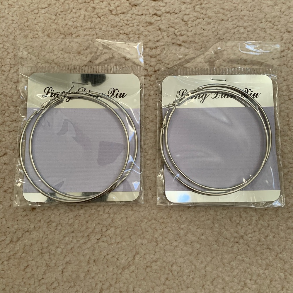 Two pairs of large hoop earrings